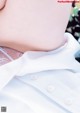 A close up of a person wearing a white shirt.