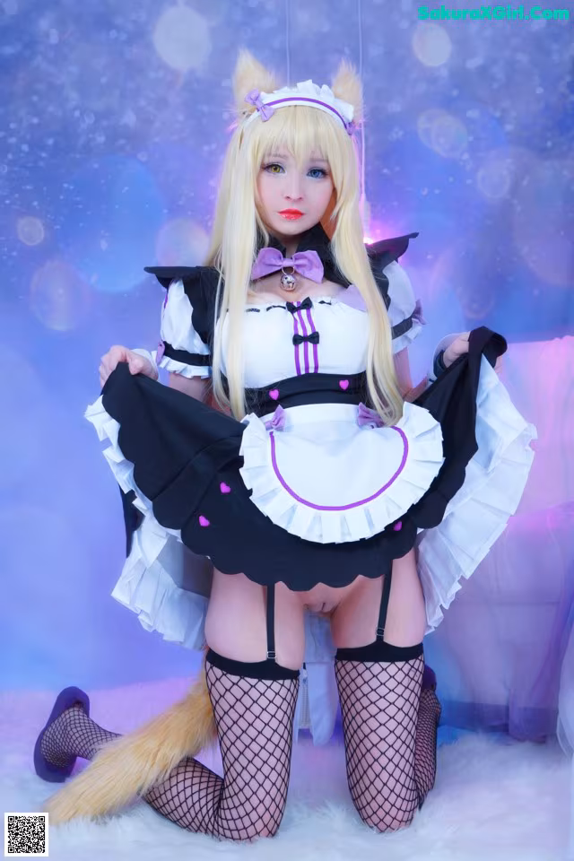 A woman dressed in a maid outfit posing for a picture.