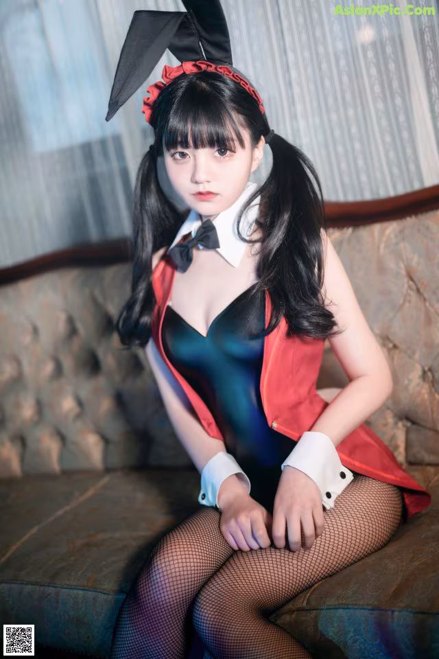 A woman in a bunny costume sitting on a couch.