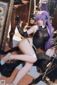 A woman with purple hair sitting on the floor next to a mirror.