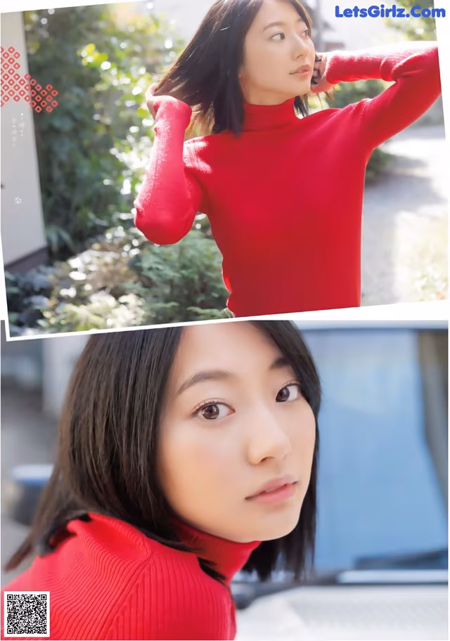 A woman in a red turtleneck sweater is posing for a picture.