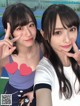 Two young women posing for a picture on a tennis court.