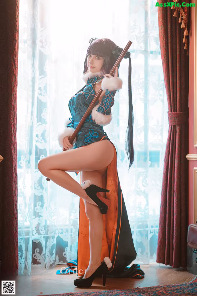 A woman in a blue and orange outfit holding a rifle.