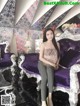 A woman sitting on a purple couch in a room.