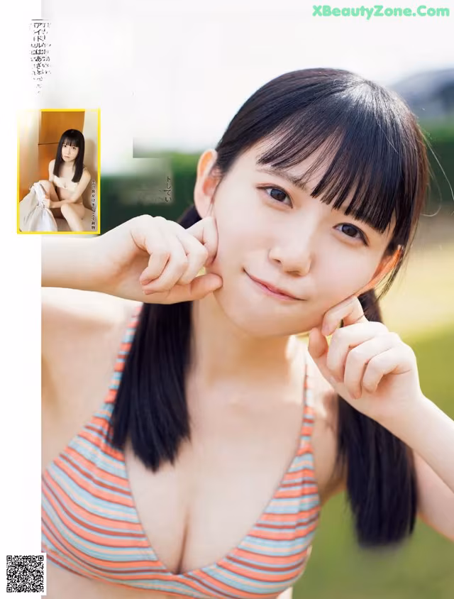 A woman in a striped bikini posing for a magazine.
