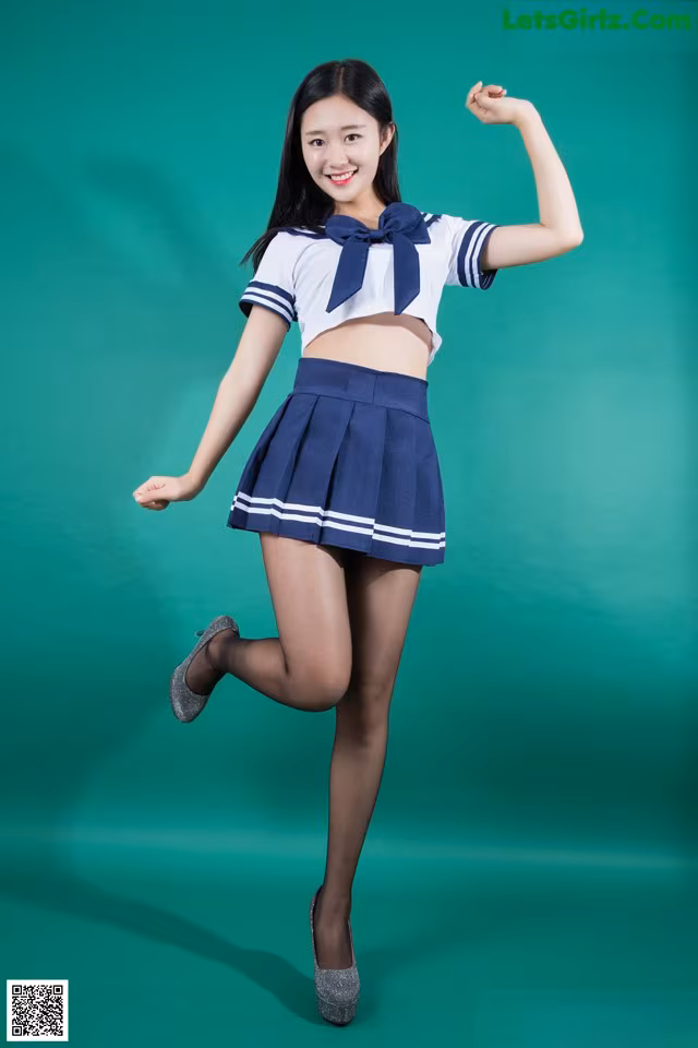 A woman in a school uniform posing for a picture.