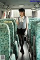 A woman in a uniform is standing on a train.